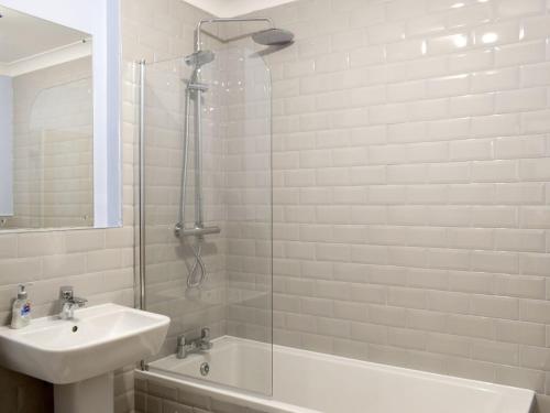 a bathroom with a sink and a tub and a shower at The Barn in Fintry