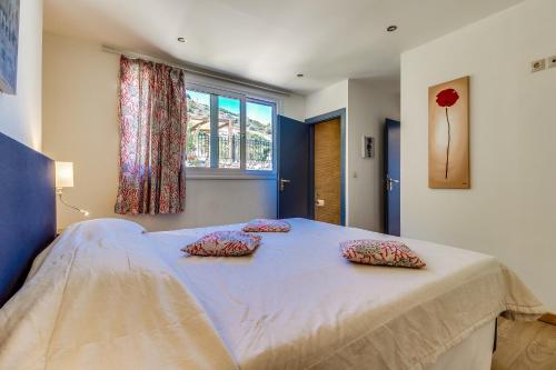 a bedroom with a large bed with two pillows on it at Istron Collection Villas in Istron