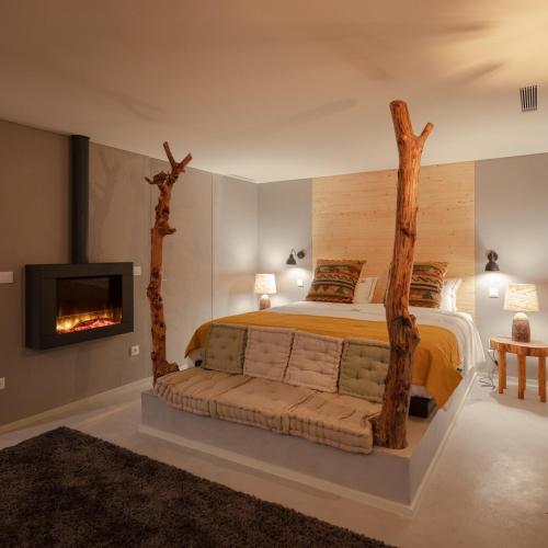 a bedroom with a bed with fake trees on it at Porto Deluxe Apartments in Porto