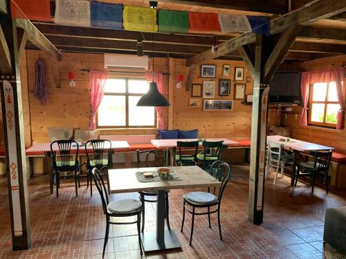 a dining room with tables and chairs in a cabin at Planinarski dom "Tornik" Zlatibor in Ribnica