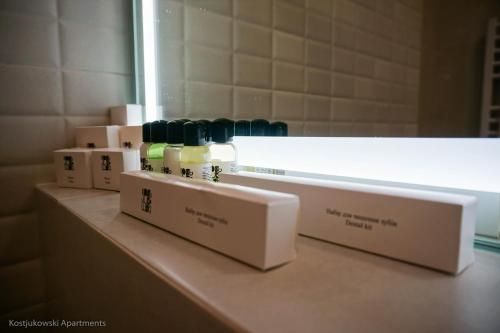 a shelf in a bathroom with some bottles on it at Kostjukowski Apartments Forum in Lviv