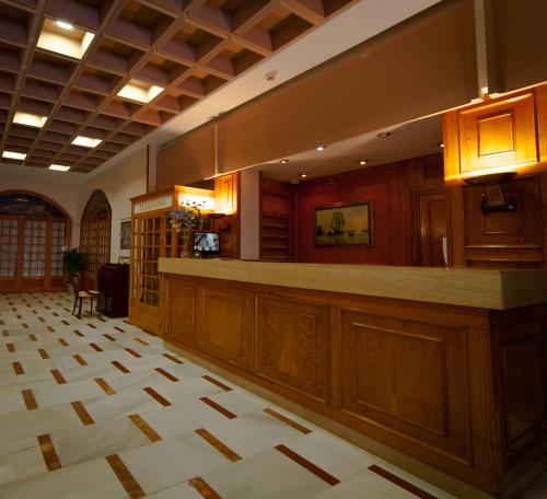 a large lobby with a bar in a building at Hotel Regio 2 in Cádiz