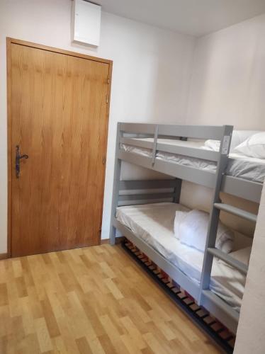 a room with two bunk beds and a door at Samoens - E12 in Samoëns