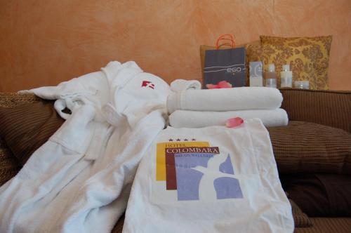 a pile of towels sitting on top of a couch at Relais La Colombara Spa & Wellness in Travo
