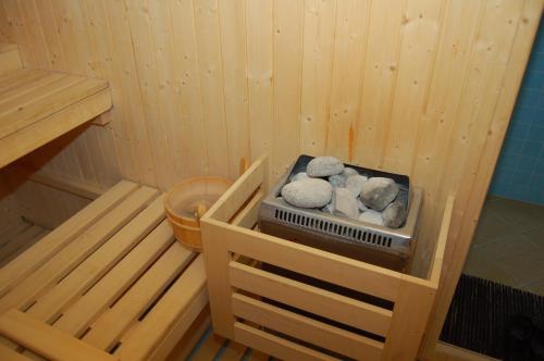 a toy sauna with rocks on a shelf in it at Relais La Colombara Spa & Wellness in Travo