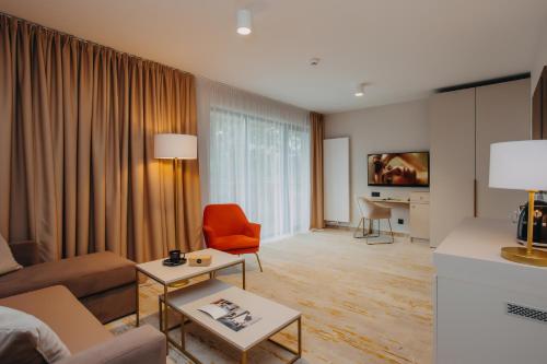 a living room with a couch and a table at Five Seasons Szklarska Poręba in Szklarska Poręba