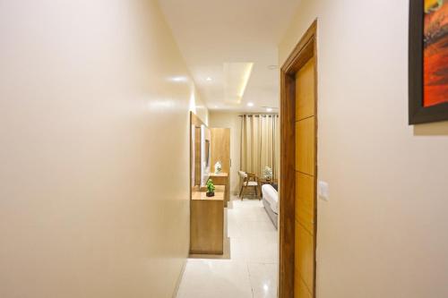 a hallway leading to a living room in a house at Hotel Worth - Near Railway Station in New Delhi
