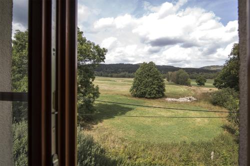 a view of a field from a window at Penzion Linden in Oldřiš