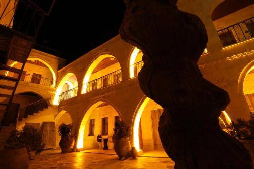 a building with a statue in the middle of a courtyard at Duven Hotel Cappadocia in Uchisar