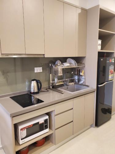 a kitchen with a sink and a microwave at The Song Luxury Condotel Vung Tau - Căn hộ cao cấp Luca's House in Vung Tau