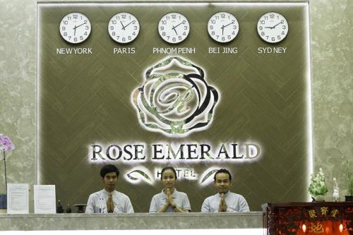 a group of men standing in front of a wall with clocks at Rose Emerald Hotel in Phnom Penh