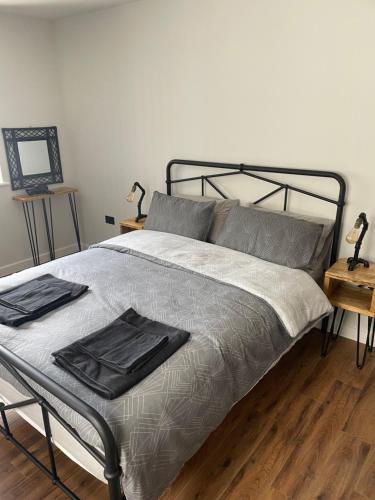 a bedroom with a bed with a metal frame at The New 2 Plas Morolwg in Aberystwyth