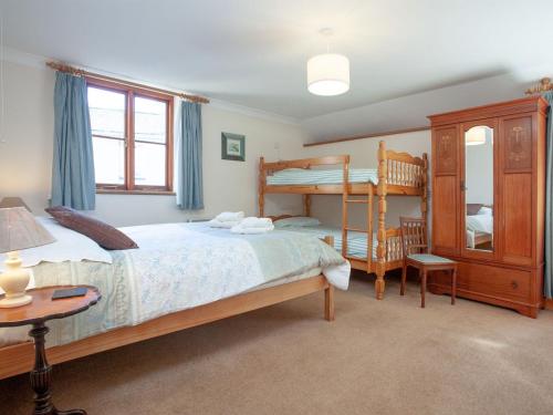a bedroom with a bed and a bunk bed at The Coach House - Uk35953 in South Pool