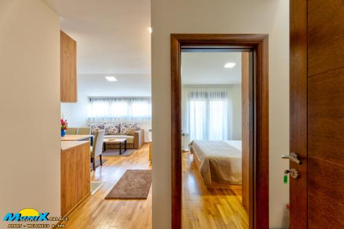 a room with a bed and a room with a dining room at Monix Palace Zlatibor in Zlatibor