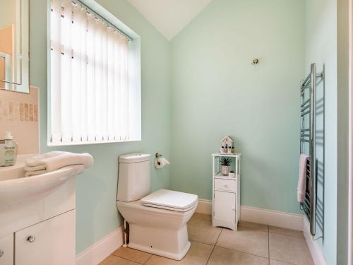 a bathroom with a toilet and a sink at The Stables - Uk36121 in Horsington