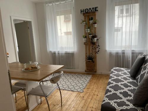 a living room with a table and a couch at Casa Papaja in Viersen