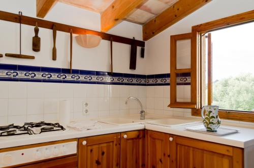 a kitchen with a sink and a stove at Agroturisme s' Horta in Capdepera