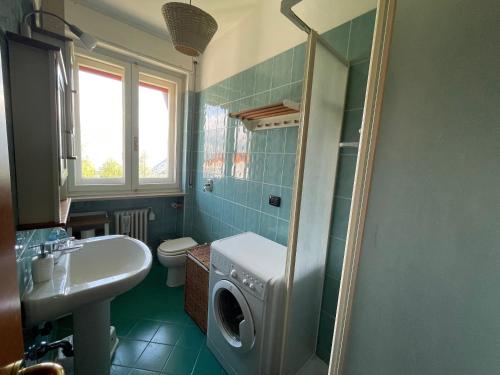 a bathroom with a sink and a washing machine at The Panoramico in Sauze dʼOulx