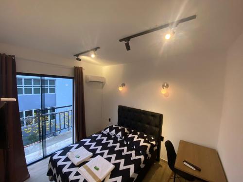 a bedroom with a bed and a large window at Pousada Leitzke in Piratini