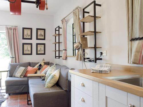 a living room with a couch and a sink at The Pump House in Kiddemore Green