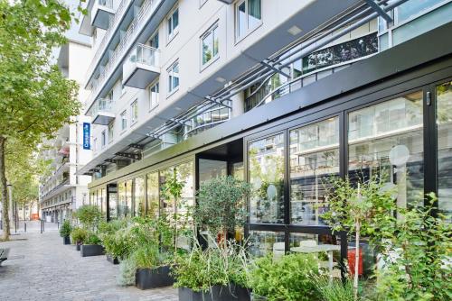 a building with plants on the side of it at Hotel Campanile Paris-Bercy Village in Paris