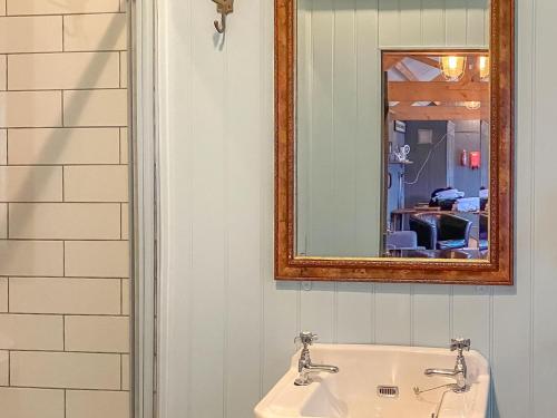 a bathroom with a sink and a mirror at Southfield Workshop in Braunston