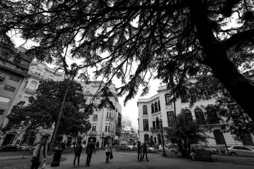 a group of people walking on a street in front of buildings at Zabalita, hermoso y cálido loft en la Ciudad Vieja in Montevideo