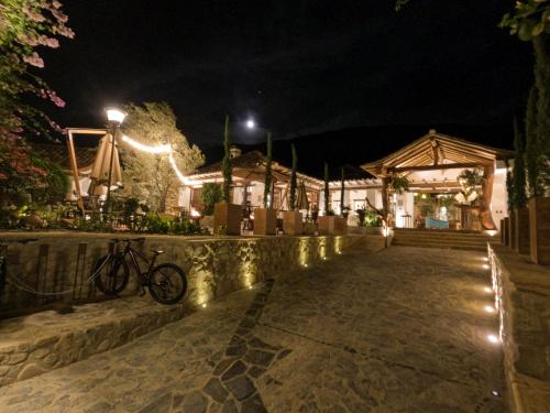 a bike parked in front of a building at night at Hotel Boutique El Carmel in Villa de Leyva