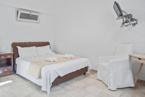a bedroom with a bed with two towels on it at Scenic Seaview villa Iris at Faragas in Angairiá