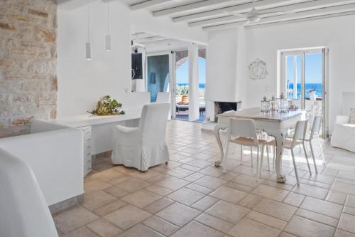 a kitchen and dining room with a table and chairs at Scenic Seaview villa Iris at Faragas in Angairiá