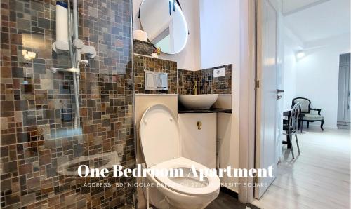 a bathroom with a toilet and a sink at Rosuites Apartment Accommodation in Bucharest