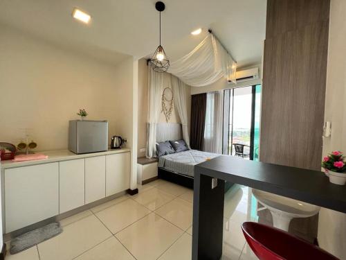 a bedroom with a bed and a table in a room at Private Condo Port Dickson Waterfront in Port Dickson