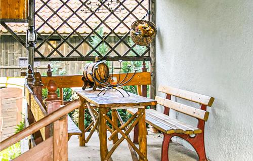 a wooden table and a chair on a porch at Nice Home In Lidzbark Warminski in Lidzbark Warmiński