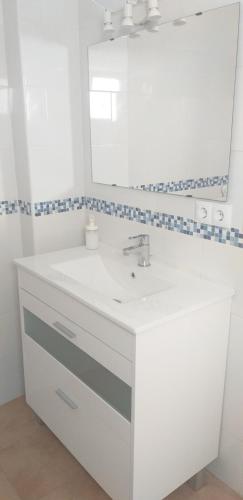 y baño con lavabo blanco y espejo. en C&BLOLA - Habitacion independiente con baño privado y aire acondicionado - Minimo 3 dias en Puerto Real