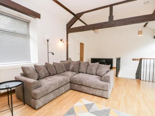 a living room with a couch and a table at Coach House in Carnforth