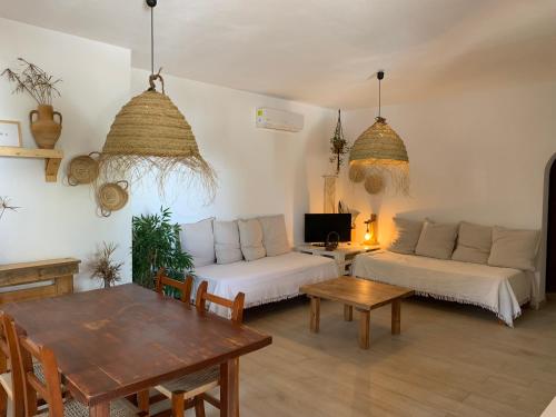 a living room with a couch and a table at Appartamentos Michel Dos in Sant Ferran de Ses Roques