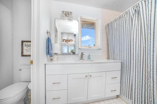 a white bathroom with a sink and a mirror at The Harmony Studio at Wind Walker Homestead in Spring City