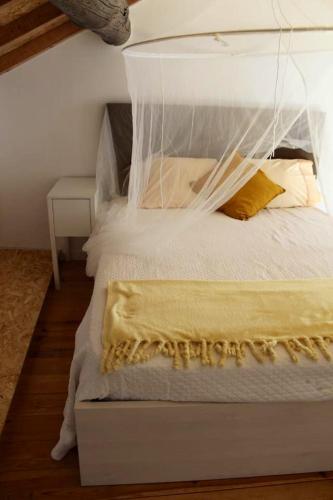 a bedroom with a white bed with a blanket on it at Comfortable Apartment with Pool in Marco de Canaveses - 50 m² in Marco de Canavezes