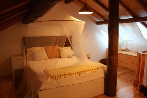 a bedroom with a bed with a canopy at Comfortable Apartment with Pool in Marco de Canaveses - 50 m² in Marco de Canavezes