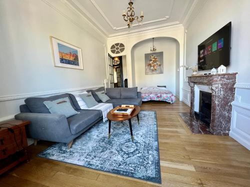 a living room with a couch and a fireplace at Le Téléphérique, vue Bastille, 6 pers, 300 m Gare in Grenoble