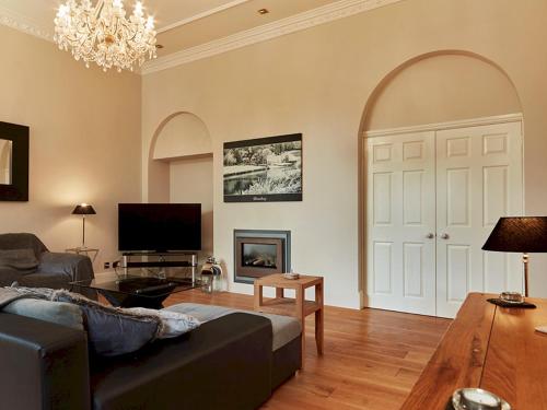 a living room with a couch and a fireplace at Luxury 5 bedroom Riverside home in town centre - Pass the Keys in Shrewsbury