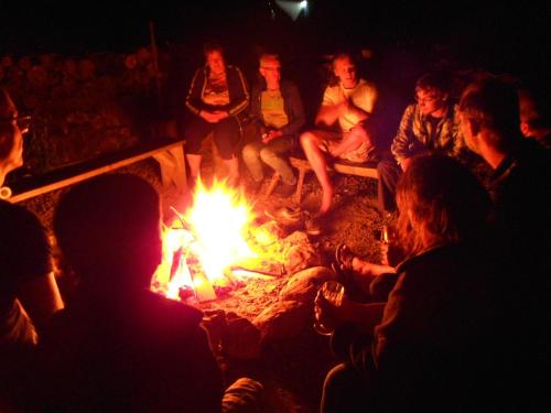 a group of people sitting around a fire at Apartment at Sedliacky Dvor - Brezno in Brezno