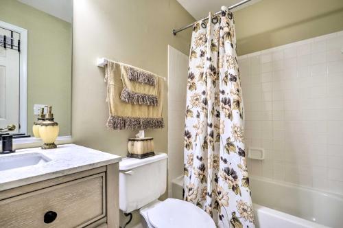 a bathroom with a toilet and a shower curtain at Woodbridge Townhome with Pool Table, Pond Views in Woodbridge