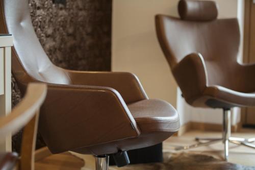 two chairs sitting next to each other in a room at Boutique Hotel Gams in Oberstdorf