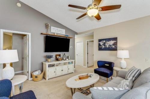a living room with a couch and a flat screen tv at Sunrunner Cottage in Pensacola