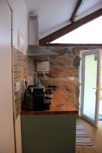 a kitchen with a counter top with a microwave at Charming Studio in Marco de Canaveses - 25m² with Pool in Marco de Canavezes