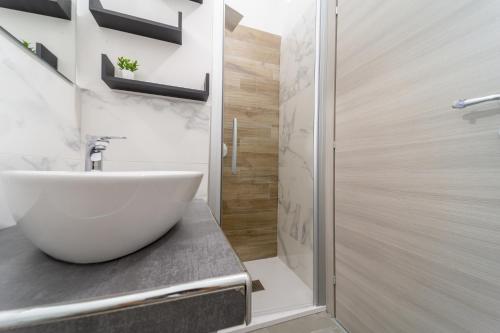 a bathroom with a white sink and a shower at Residenza Digione in Parma