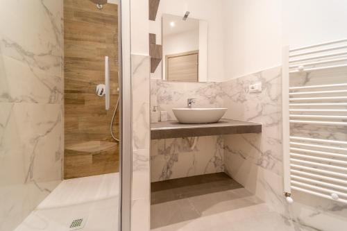 a bathroom with a sink and a shower at Residenza Digione in Parma