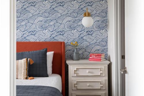 a bedroom with a blue and white patterned wall at NEW HAPPY TRAIL 2BR CONDO CLOSE TO DOWNTOWN in Traverse City