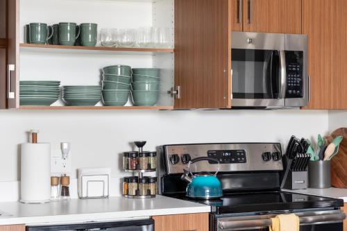 a kitchen with a stove and a microwave at NEW HAPPY TRAIL 2BR CONDO CLOSE TO DOWNTOWN in Traverse City